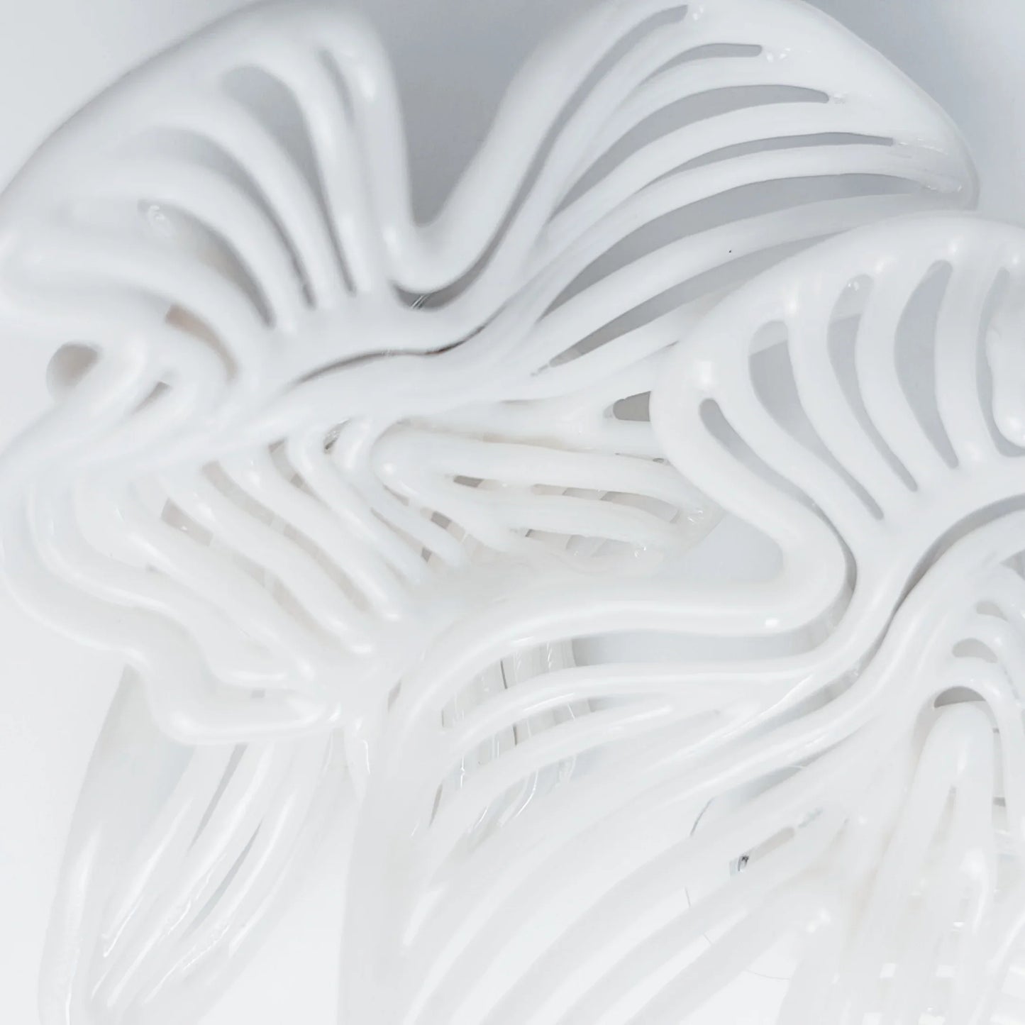 Detailed shot of the small piece of jewelry, highlighting the 3D-printed resin texture.