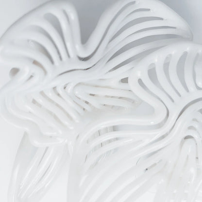 Detailed shot of the small piece of jewelry, highlighting the 3D-printed resin texture.