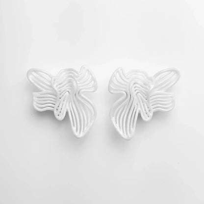 Frontal shot of the pair of bridal shower jewelry, showing the flowing sculptural design