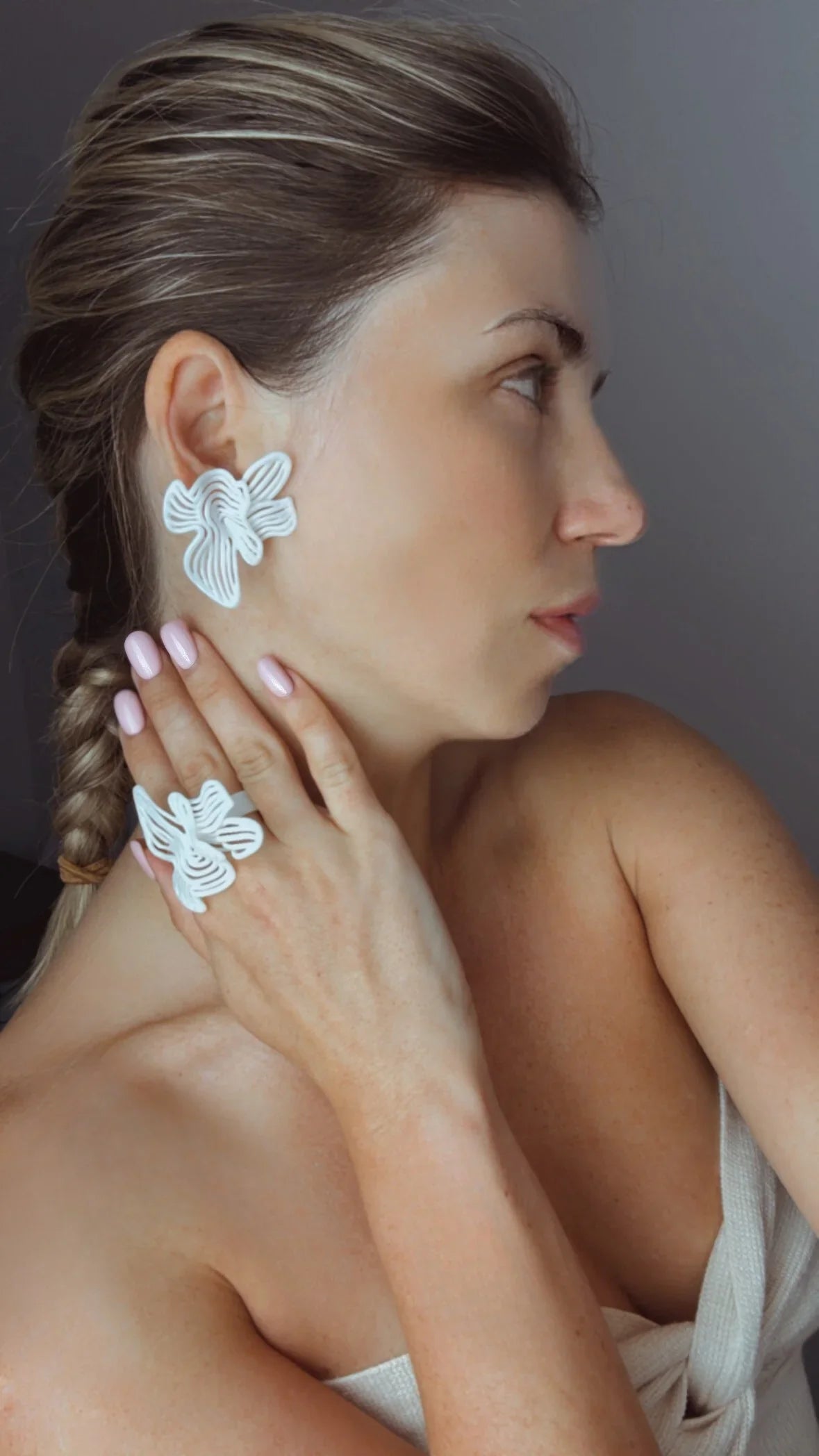 Elegant fashion jewelry in white, worn as a stylish jewelry wedding guest accessory.