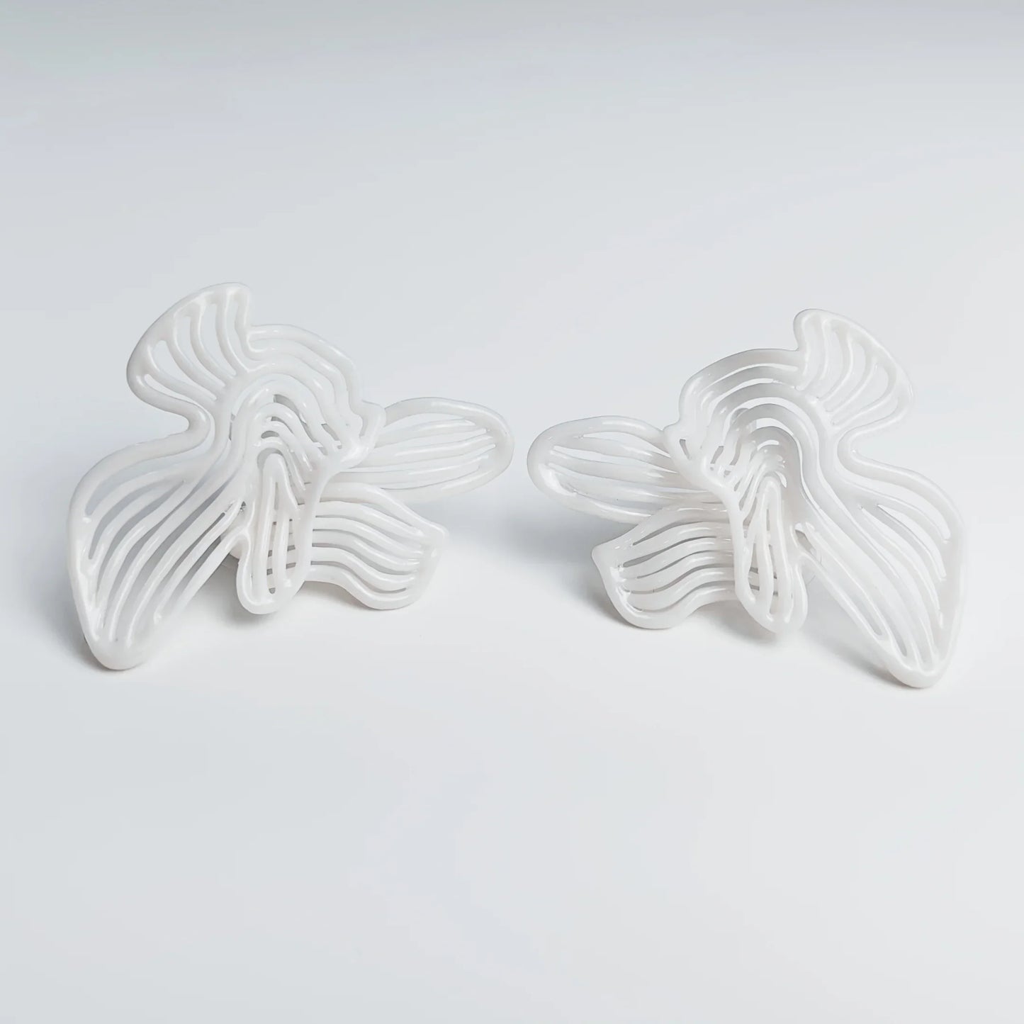 Photo of elegant fashion jewelry in natural light, showcasing the pure white finish