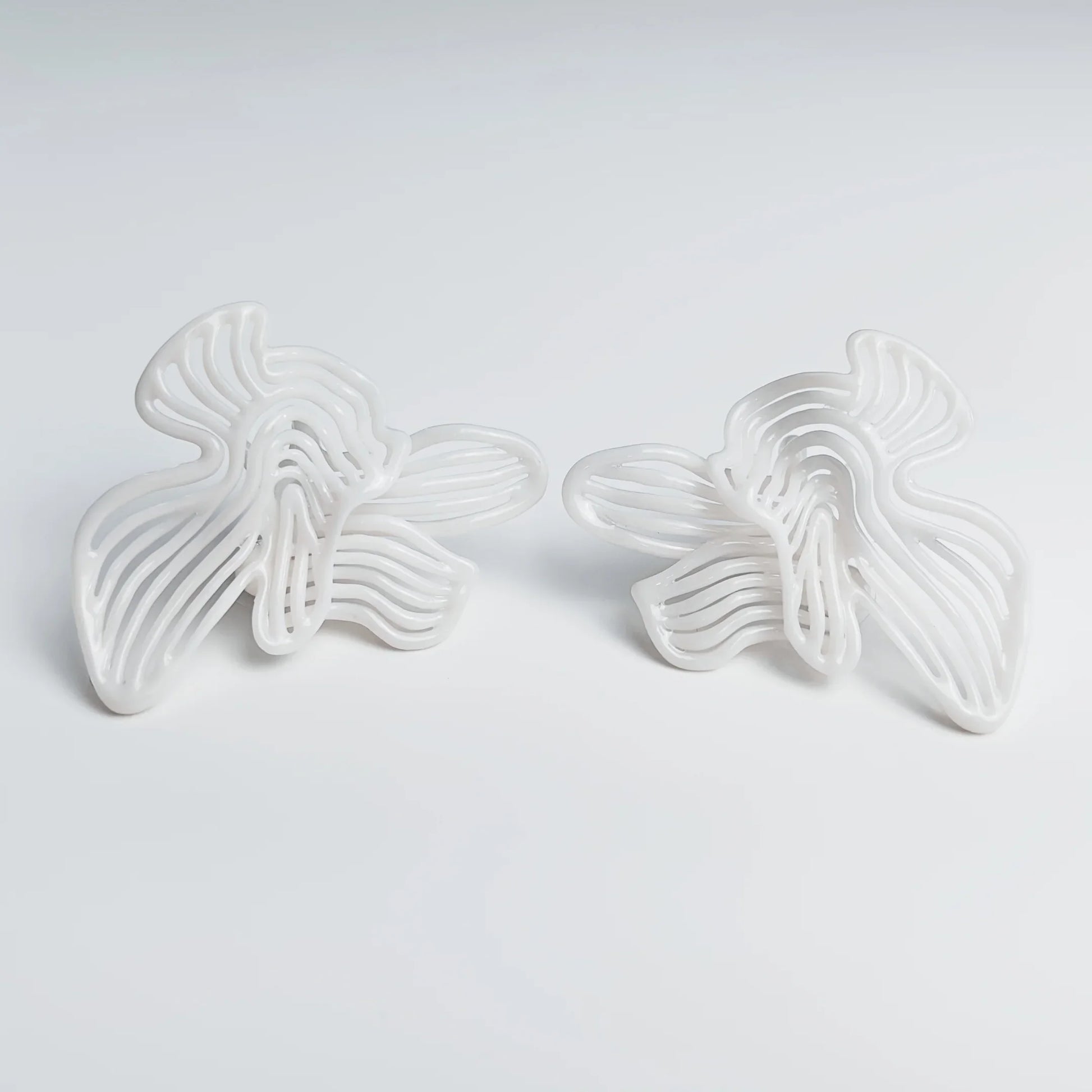 Photo of elegant fashion jewelry in natural light, showcasing the pure white finish