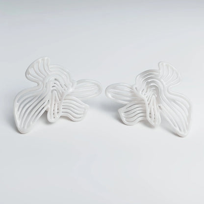 Photo of elegant fashion jewelry in natural light, showcasing the pure white finish